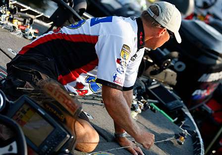 Russ Lane sets out his rods and prepares for the second day of competition on the Alabama River.