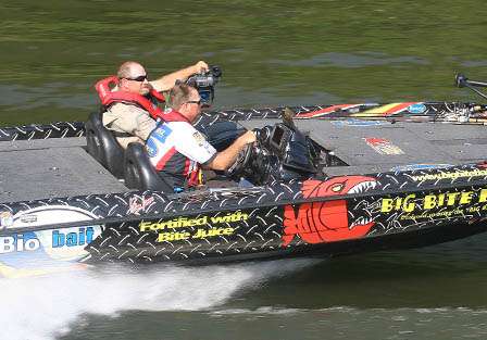 Russ Lane boats south on the Alabama River while cameraman, Rick Mason captures the action. 