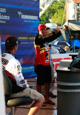 Elite pro Kevin VanDam holds up his fish, as he officially knocks the current leader, Edwin Evers, out of the hot seat.