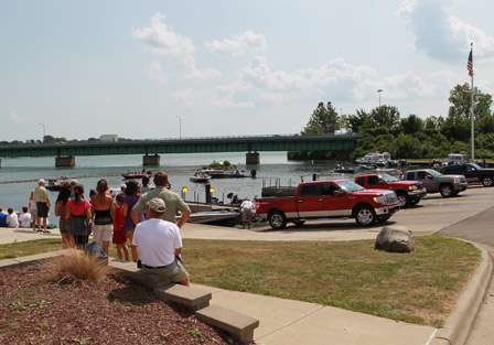 Fans watch as the first flights pull their boats from the water.