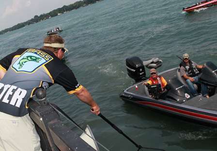 Stacy Twiggs reaches out to catch a key fob, checking in another angler for the Day Two weigh-in.