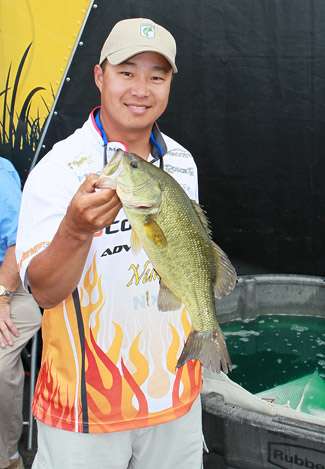 Moo Bae shows off a healthy largemouth from the Upper Chesapeake Bay after he steps off stage with his official weight.