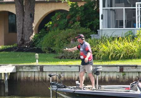 Randy Elliot flips to a dock mid-day, hoping the bass are in tight to cover with the bluebird skies overhead.