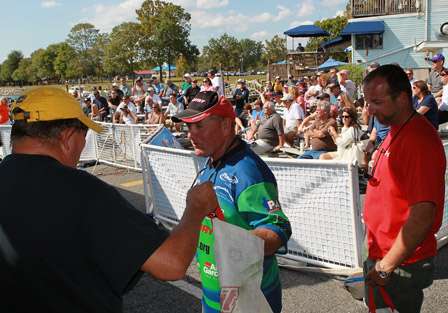 Local angler Rick Ash takes his fish and heads to the stage to get an official weight.