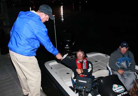 Tournament Director Chris Bowes checks Darin Dolls paperwork at the dock before launch time.