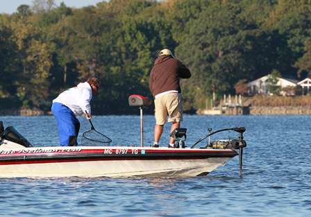 Recomposed, Wellman goes back to work hauling in another bass that gives him fits at the side of the boat.