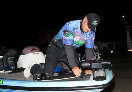 John Cromwell mounts his front navigational light as he readies his boat for the first day of competition.