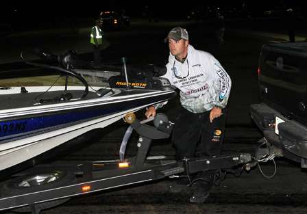 Trevor Fitzgerald unhooks his boat from the trailer as he readies for launch on the ramp.