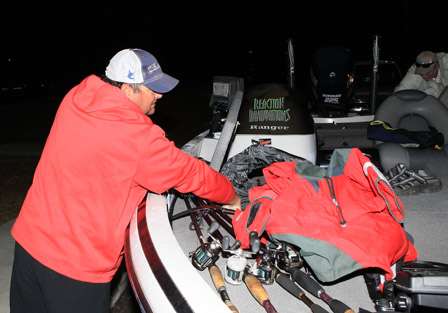 Andre Moore reaches for his cold gear -- with the temps in the lower 50s, it will make for a chilly morning run on Lake Seminole.