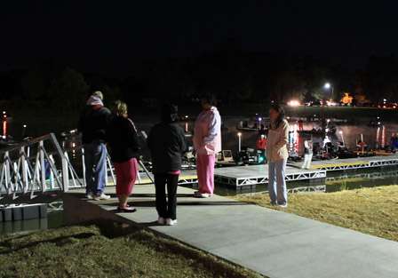 Fans and family members start to gather an hour before launch, watching the preparation unfold at the boat basin.