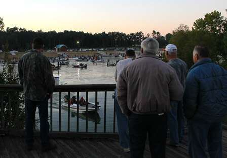 Fans watch from an overlook as the first boat heads toward the river and out onto Lake Seminole.