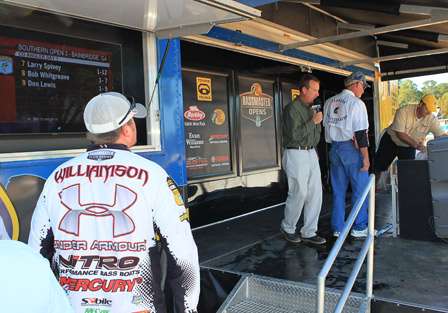 Jason Williamson stands at the side of the stage as he waits to get an official weight on his three fish.