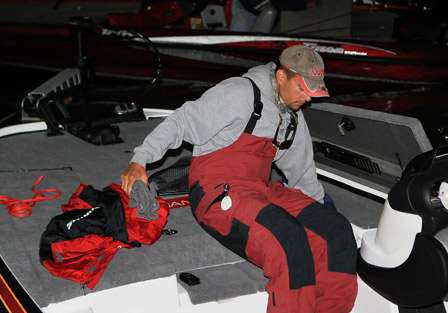 Pro Trevor Knight digs into his boat's storage box for his cold gear as he waits to use the new mega-ramp at the Earl May Boat Basin.