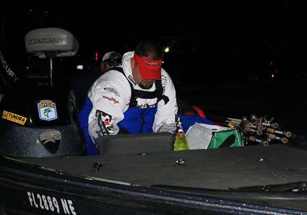 Pro Jeff Brooks helps out his co-angler by placing his drinks in the boat's cooler while his co-angler loads the rest of his gear into Brooks' boat.