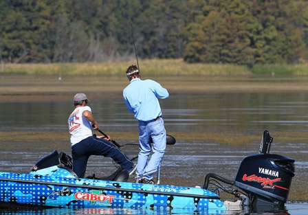 Co-angler Rob Newell gets a little help from pro Jimmy Kennedy as he fights a bass to the boat.