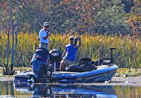 With a little help from his co-angler and the net, he is able to land a good bass.