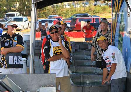 The final pros stand to the side of the stage as Fred Hood, the co-angler division champion receives his trophy and talks about his tournament.