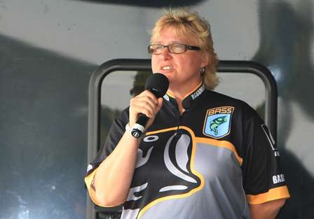 Tournament Manager Deb Wilkinson sings the national anthem before the start of the weigh-in. 