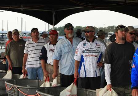 The first flight of anglers is ready at the tanks as they watch other competitors weigh-in ahead of them.