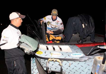 Pro Keith Combs (right) comes into the final day in first place. Here he helps his co-angler, Chris Domkowski get his gear loaded into the boat.