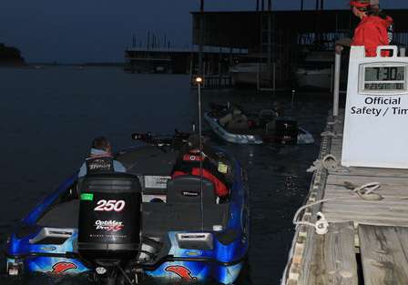 At exactly 7:30 a.m., the first bass boat takes off for the final launch of the Bass Pro Shops Bassmaster Opens.