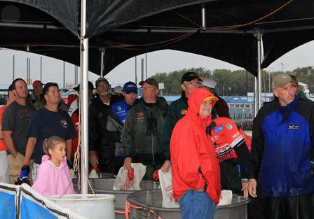 The last part of the anglers wait at the side of the stage, under a welcomed tent, as they had been fishing in the rain and storms for hours.