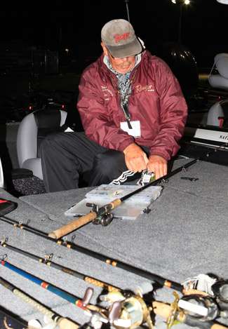 Tom Jessop has his bass weapons splayed about the deck of the boat as he reties all of his lures.