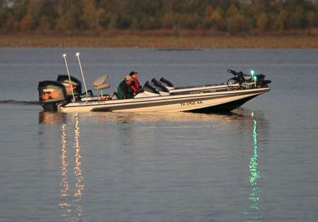 Two Skeeter bass boats shadow each other as they ease toward the launch preparation area.