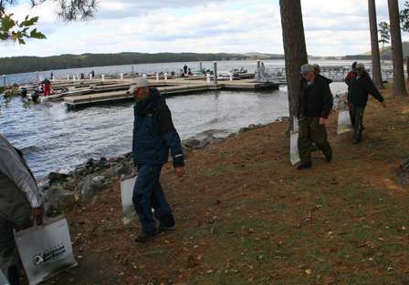Anglers walk to the weigh-in line with their bags of Lake Guntersville bass.