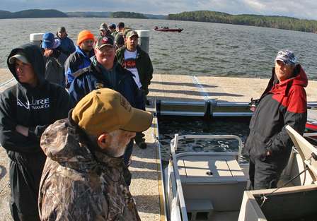 Anglers line up near the live-release boat to get a bag for their fish.