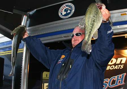 McGouirk shows off the two fish he boated on Day Four, part of his winning stringer of 41.76 pounds.