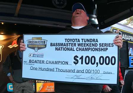 Holding the $100,000 first-place check, McMurtury shows some emotion after winning the tournament.