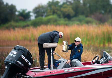 Jeremy Prouty holds up a big Kissimmee Chain bass before slipping it into his livewell.