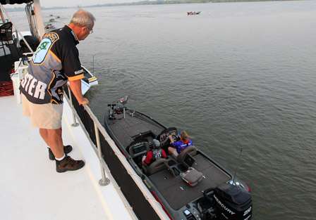 BASS Opens Tournament Manager Bruce Mathis checks live wells from the second floor of a house boat at Red River Marina South.