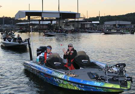 Co-angler Randall Vaughn catches the boat number while Cheryl Spencer repeats her check-in time to the BASS officials.