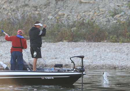 As the bass breaks the top of the water, Johnston recalls the net after seeing it was only a striper.