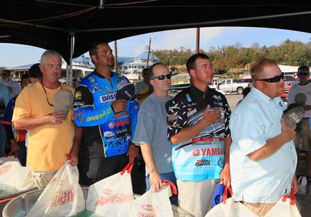 The anglers honor the flag as the national anthem is played prior to the start of the official Day One tournament weigh in.