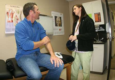 Clinical supervisor Jonie Hall talks to Browning about his elbow pain.