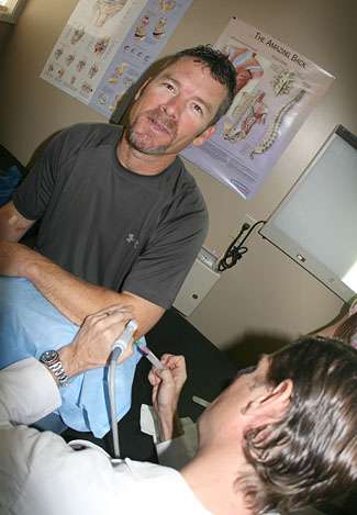 Sloan injects Browning's left elbow, using the ultrasound machine to pinpoint the area of concern.