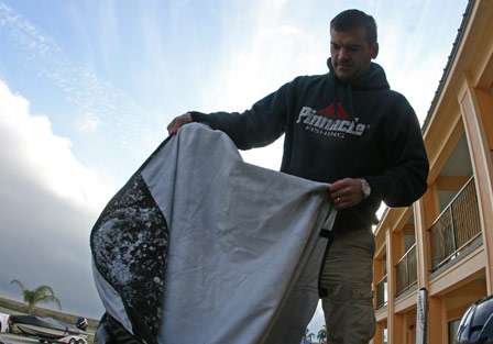 Dave Wolak shows off his boat cover, which was covered in ice and snow from the ride down.

