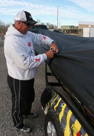 Randall Tharp covers his boat after a long day of practice on the Louisiana Delta.