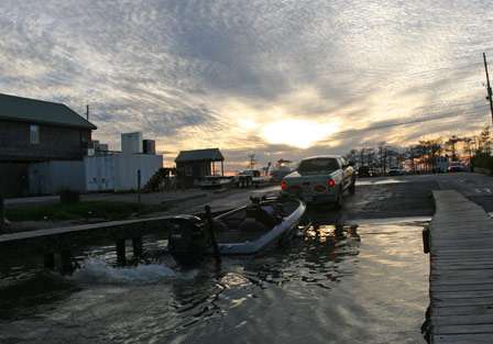 The sun is beginning to set as Cliff Pace trailers his boat after a day of fishing from Venice, La.