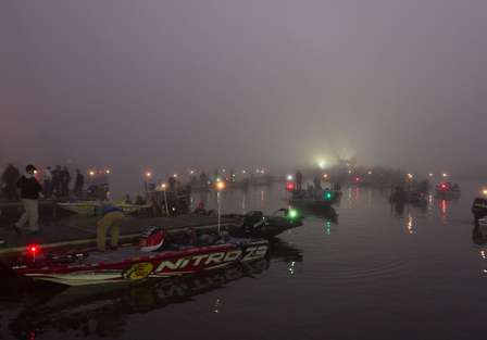 The anglers wait with anticipation for the fog to lift.