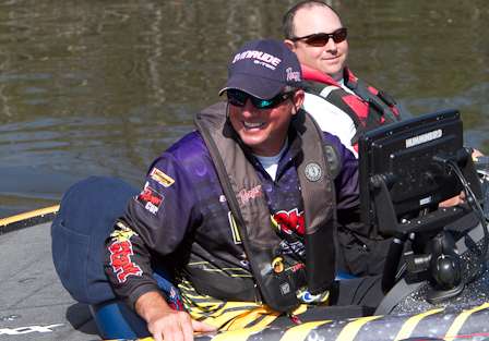 Tharp chats with a spectator boat as he idles back up the canal before resuming his fishing.