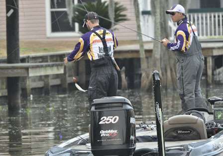 Travis Laurent and Douglas McClung boat a short fish.