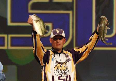 An LSU angler holds up his fish after a good day on the water.