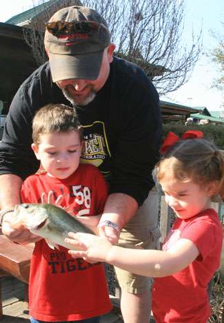 Now calmed down, Dylon gives the bass a feel, but sister Audra, 4, wasn't afraid to pet it.