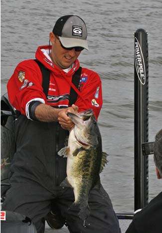 Marty Robinson admires his lunker bass. The fish anchored an 11-3 stringer.