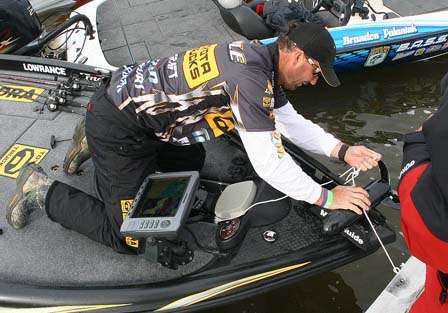 Gerald Swindle works on tying his boat on Day One.