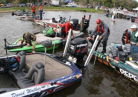 Bill Lowen and Gary Klein push boats around on the dock to make room for more anglers.